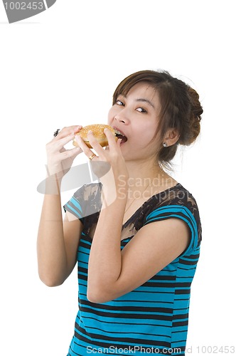 Image of young woman eating a hamburger