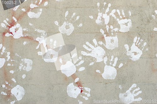 Image of handprints on cement wall