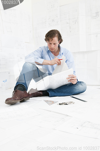 Image of Engineer checking technical drawings