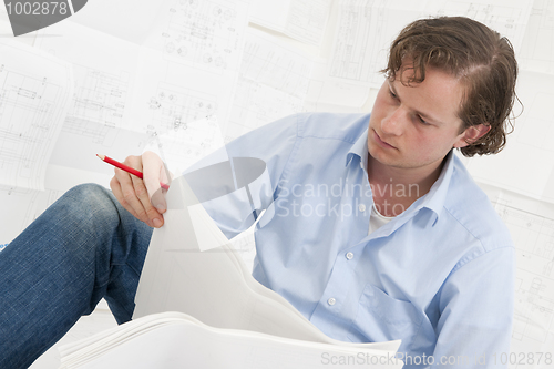 Image of pn[5DNYS6S] Mechanical engineer checking drawings