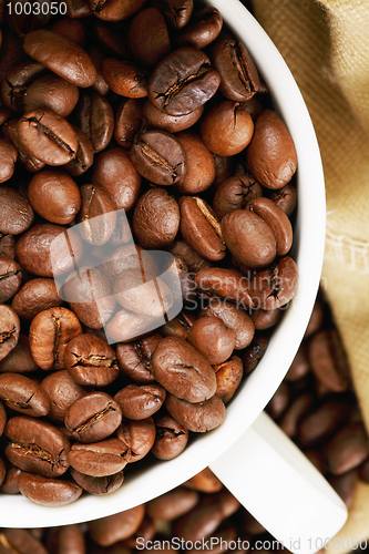 Image of Half of white cup with coffee above view closeup
