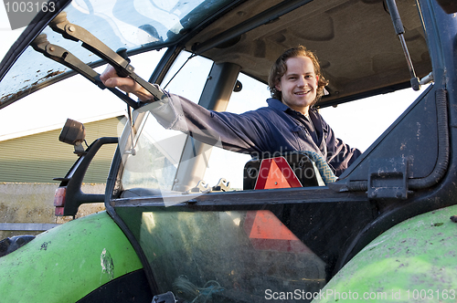 Image of Farm hand in a tractor