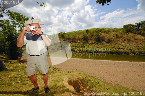 Image of Turist is taking a picture with camera