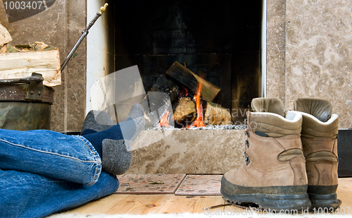 Image of Hiker resting by the fireplace