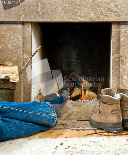 Image of Hiker resting by the fireplace