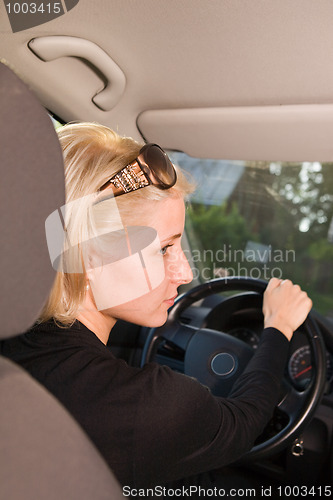 Image of Young woman driving car