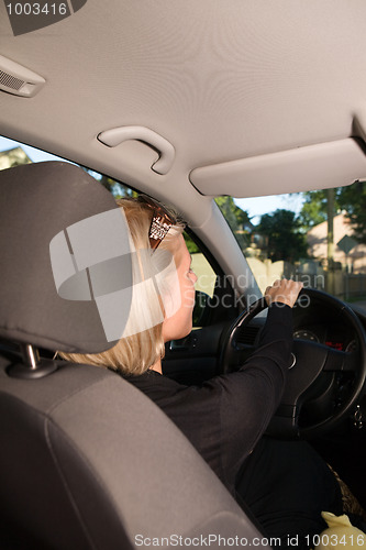 Image of Young woman driving car