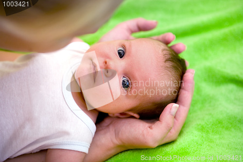 Image of adorable newborn baby in mother's hand 