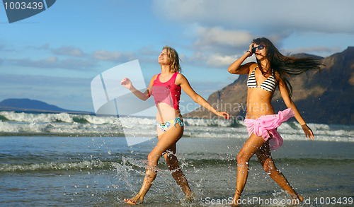 Image of two beautiful woman on beach 