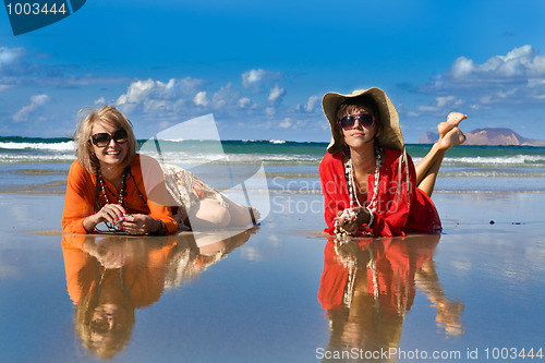 Image of beautiful woman lays on beach