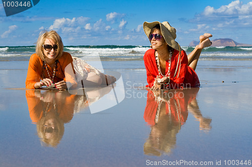 Image of beautiful woman lays on beach