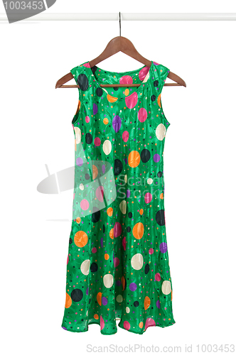 Image of Bright green dress on a wooden hanger