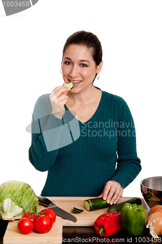 Image of Woman cooking in kitchen