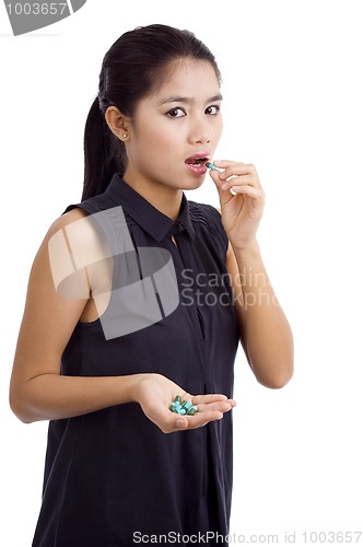 Image of woman taking medicine