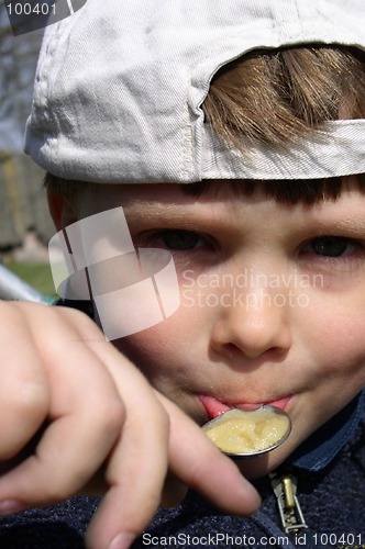 Image of Boy Eating Honey