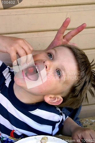 Image of Boy Eating a Cherry