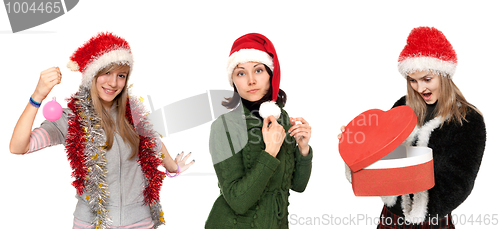 Image of Three girls in cristmas hat with gift