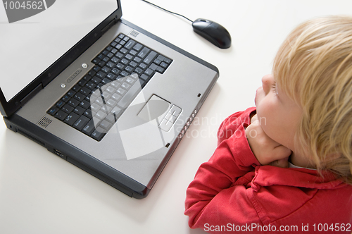 Image of Boy behind laptop