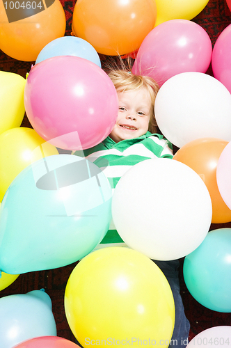 Image of Boy surrounded by baloons