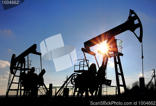 Image of two oil pumps silhouette