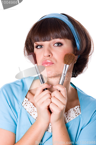 Image of woman with two make-up brushes 