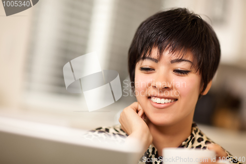 Image of Pretty Smiling Multiethnic Woman Using Laptop