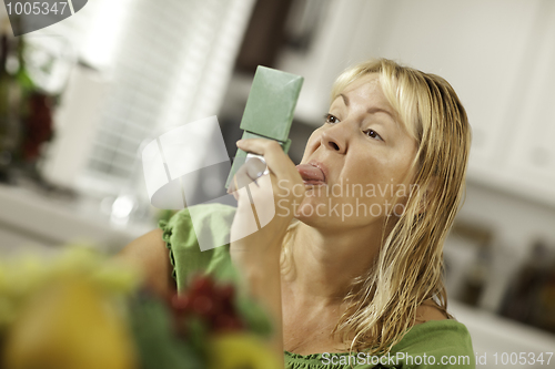 Image of 
Woman Sticking Her Tongue Out at Herself in a Mirror