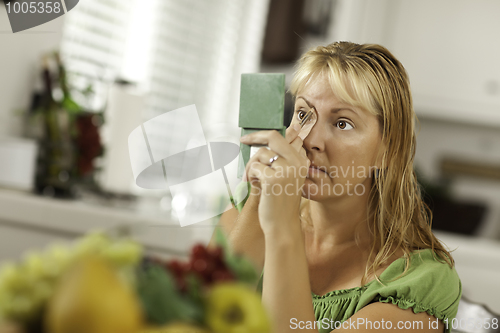 Image of Blonde Woman Applying Her Makeup
