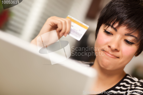 Image of Smiling Multiethnic Woman Holding Credit Card Using Laptop