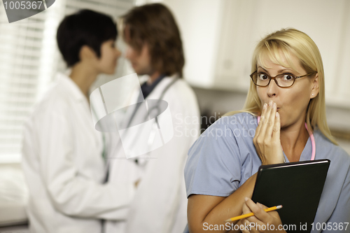 Image of Alarmed Medical Woman Witnesses Colleagues Inner Office Romance.