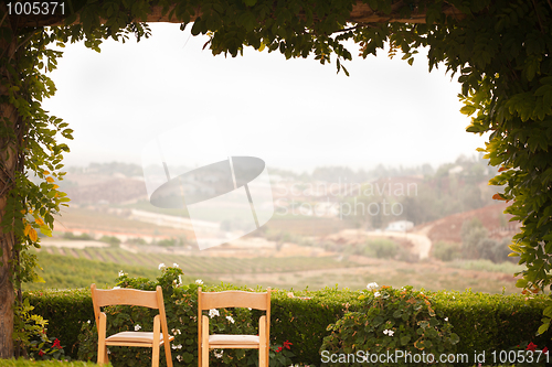 Image of Vine Covered Patio and Chairs Overlooking the Country
