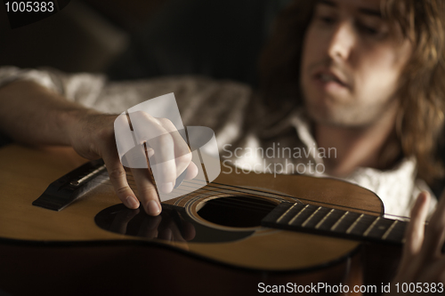 Image of Young Musician Plays His Acoustic Guitar
