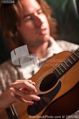 Image of Young Musician Plays His Acoustic Guitar