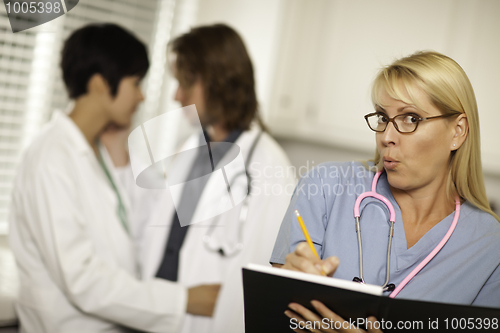 Image of Alarmed Medical Woman Witnesses Colleagues Inner Office Romance.