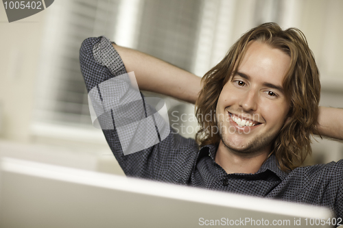 Image of Happy Young Man Using Laptop Computer