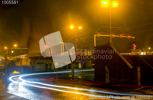 Image of Waiting for a closing bridge during a heavy shower at night