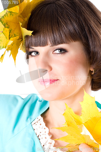 Image of beautiful young woman with yellow leaves