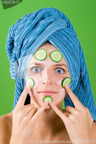 Image of woman in blue towel and mask from cucumber