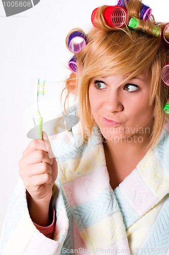 Image of housewife with curlers and toothbrush