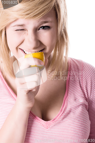 Image of young girl eating lemon 