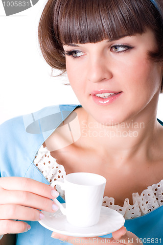 Image of young woman enjoying a cup of coffee