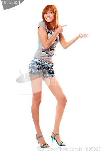 Image of Cheerful red-haired girl in a t-shirt and shorts