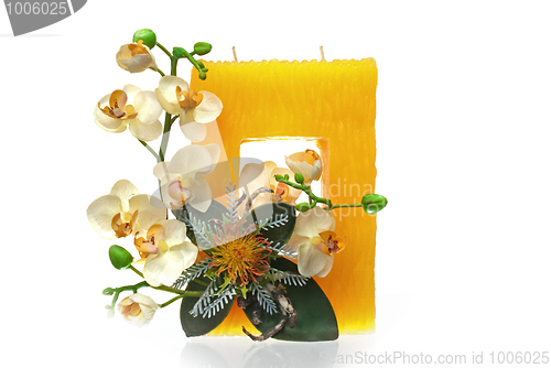 Image of Large yellow candle with the flower decoration