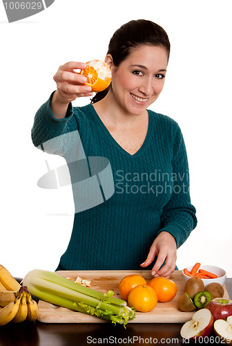 Image of Woman presenting peeled ornage fruit