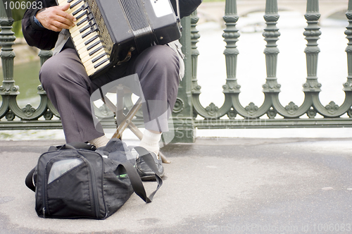 Image of Accordion player on a bridge