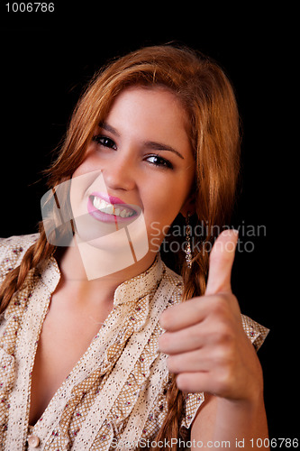 Image of Young pretty women with thumb raised as a sign of success, thumbs up