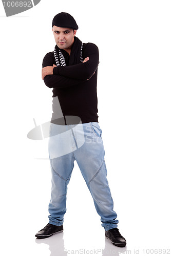 Image of Portrait of a young man serious, with arms crossed, in autumn/winter clothes