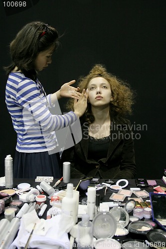 Image of Fashion model having her makeup done