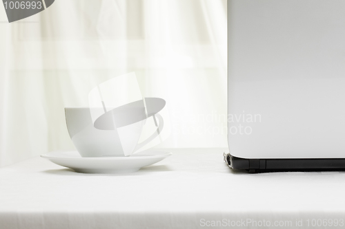 Image of Laptop and white cup