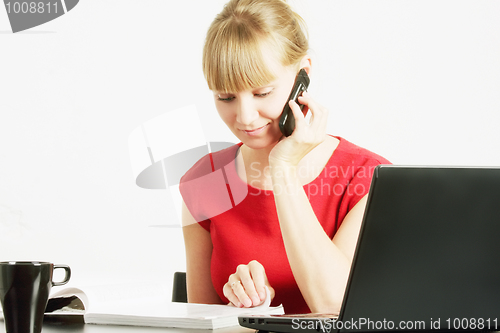 Image of Blonde woman with magazine on cellphone